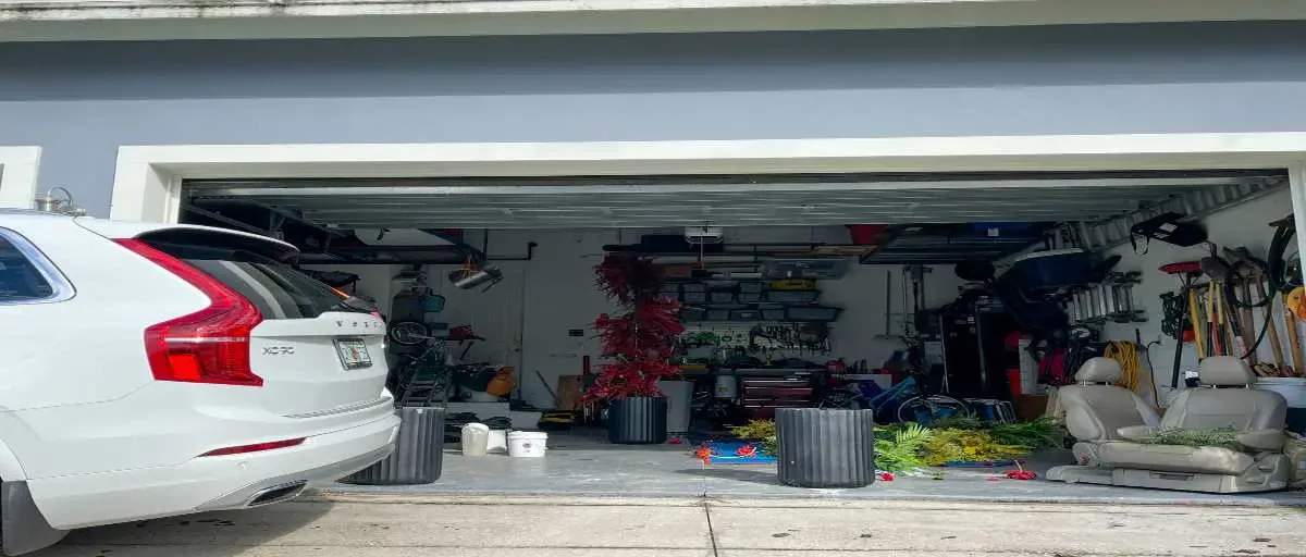 Cluttered two-car garage packed with boxes and household items before organizing